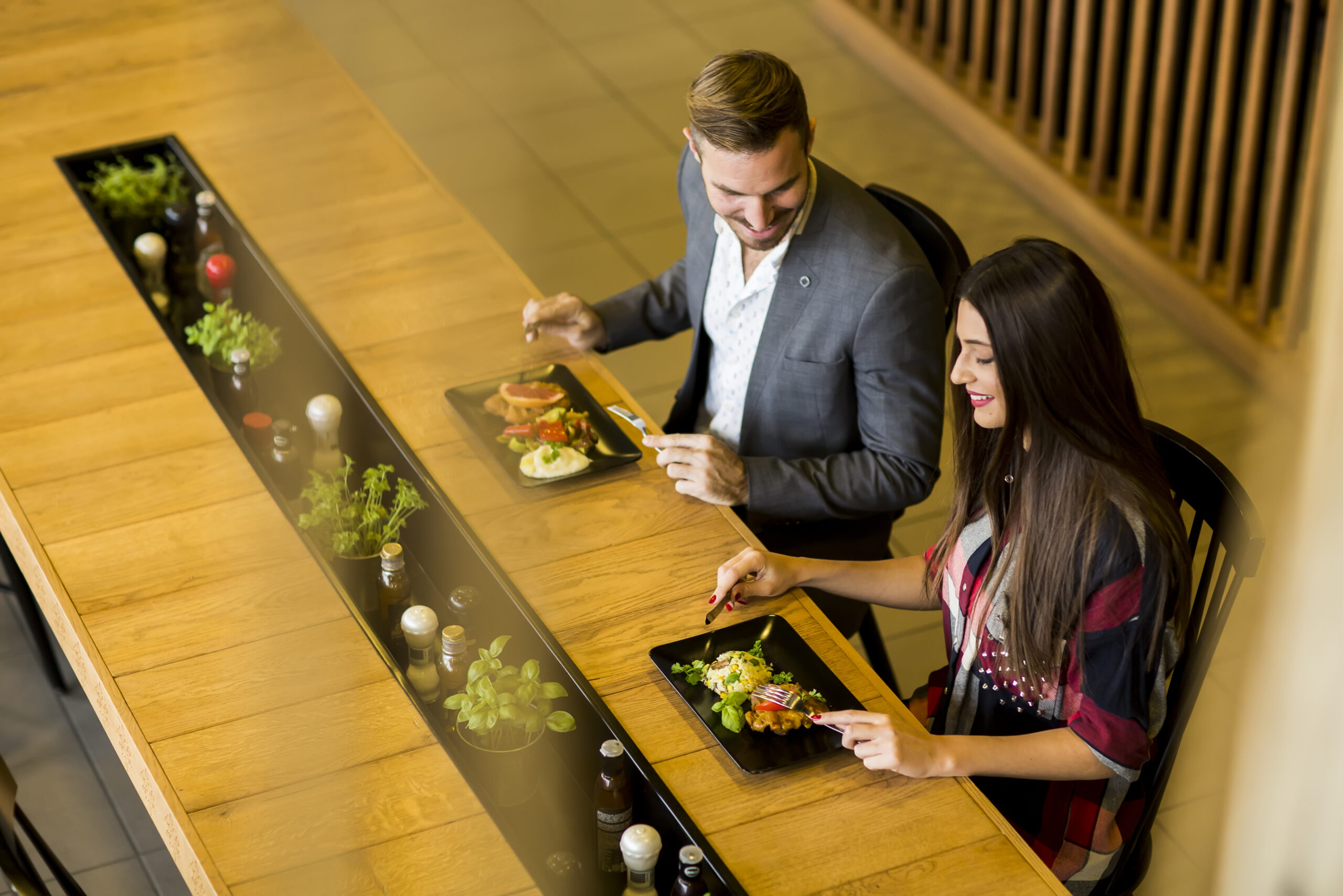Young loving couple having lunch in the modern restaurant
